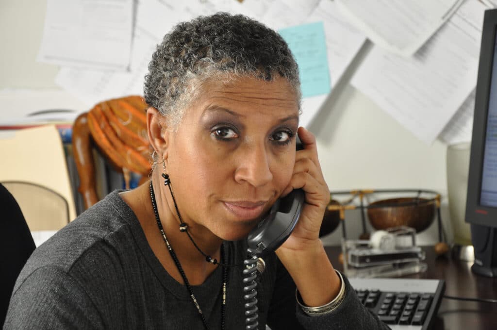 African American Professional Woman African American professional woman looking at you while on the telephone